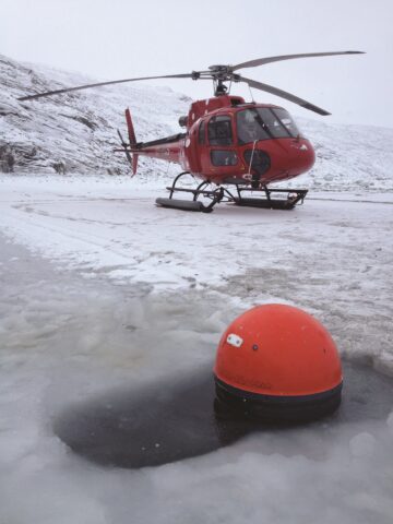 Fig. 1. A drifter being deployed through the ice in February 2012. Credit: K. Lennert 