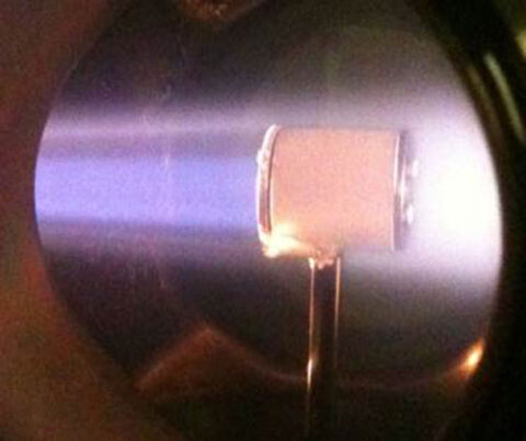 A compressed interpenetrating plasma glows within the ALEXIS device. Credit: Auburn University Plasma Sciences Laboratory.