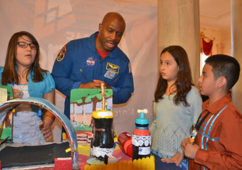 Astronaut and former NASA associate administrator for education Leland Melvin speaks to Science Fair participants Casandra Dauz, Jaleena Rolon, and Jose Valdez II. Credit: Randy Showstack
