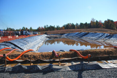 A water impoundment at a drill pad in the Fayetteville Shale gas play of Arkansas. The water will be used in the hydraulic fracturing process, where it will be combined with chemicals and sand, then used to create artificial fractures in gas-bearing rocks to allow the gas to be recovered. Credit: Bill Cunningham, USGS