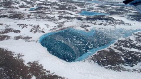 An aerial view of lake pooling on ice in Greenland. Credit: NASA/Jim Yungel, CC BY 2.0
