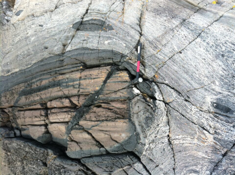 High-pressure, dense and strong eclogite (dark blocks), carried back to the surface from mantle depths by weaker, buoyant deeply subducted crust. Light-colored melts that cut these rocks were emplaced after eclogite rose from mantle depths. Credit: Andrew Kylander-Clark
