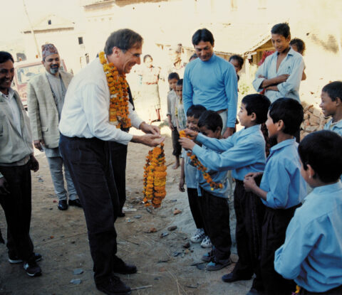 Children giving garlands to Brian Tucker at the inauguration of the school in the village of Nanghkeh in Nepal’s Kathmandu Valley. The school was retrofitted in 1998 through a joint project of GeoHazards International and Nepal’s National Society for Earthquake Technology. Credit: NSET