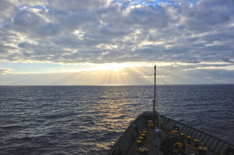 Heavy cloud layer darkens the sea off the bow of a cargo ship laden with instruments used to collect data on the stratocumulus-to-cumulus transition. Credit: Ernie Lewis