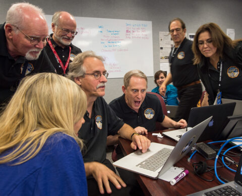 New Horizons principal investigator Alan Stern, center, along with other team members, reacts as he views new images from the spacecraft for the first time yesterday at the Johns Hopkins University Applied Physics Laboratory in Laurel, Md. Credit: NASA/Bill Ingalls