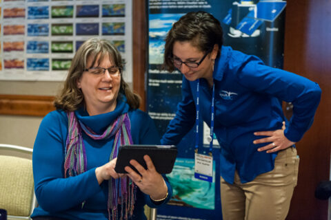 Sarah Bartholow (right), education project manager for PolarTREC, speaks with an AGU member at the 2014 GIFT Workshop. Credit: Karna Kurata