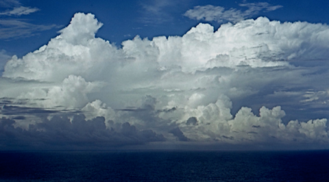 A typical large convective storm, probably without lightning, over the central Pacific Ocean. Ocean convection produces more total rain despite weaker updrafts, the strength of which defines the intensity of a storm and its capacity to develop lightning. This photo was taken from a research aircraft south of Palmyra Atoll. Credit: Edward Zipser