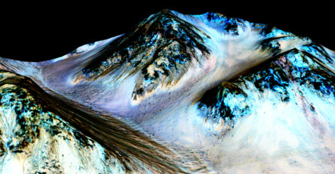 Dark, narrow streaks on Martian slopes such as these at Hale Crater are inferred to be formed by seasonal flow of water on contemporary Mars, according to NASA. The imaging and topographical information in this processed, false-color view come from the High Resolution Imaging Science Experiment camera on NASA's Mars Reconnaissance Orbiter (MRO). Planetary scientists using observations with the Compact Reconnaissance Imaging Spectrometer on the MRO detected hydrated salts on these slopes at Hale Crater, corroborating the hypothesis that the streaks are formed by briny liquid water. Credit: NASA/JPL-Caltech/Univ. of Arizona