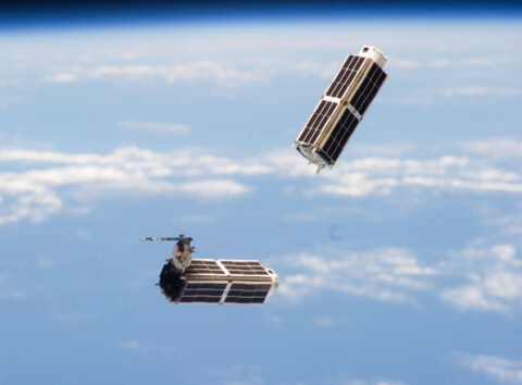 Two tiny satellites, known as NanoRacks CubeSats, speed through space last year after their February 2014 release from the International Space Station. Today, the U.S. National Reconnaissance Office (NRO) launched 13 other NRO- and NASA-sponsored CubeSats into space aboard a rocket. Credit: NASA