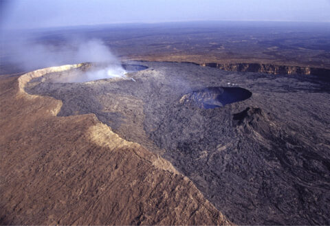 Overview of the northern part of the basaltic Erta Ale caldera, northern Afar (Ethiopia), filled with recent lava flows and hosting two pit craters, or collapsed vents. The southern pit to the right, several tens of meters wide and deep, has been hosting an active lava lake for more than a century. Credit: Valerio Acocella