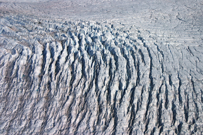 Crevasses open up as ice flows over a bedrock rumple in West Greenland. Credit: William Colgan