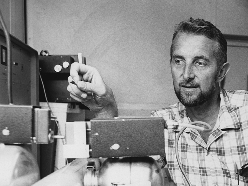 Richard P. Von Herzen examining a gamma ray attenuation porosity evaluation machine aboard the drilling ship Glomar Challenger during Leg 3 of the Deep Sea Drilling Project in 1968.