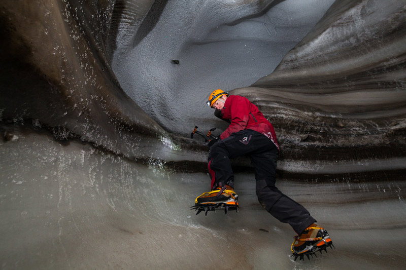 Stephen Jennings navigates the cave’s icy walls with crampons attached to his boots.