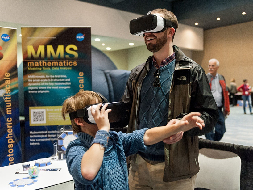 Visitors to Exploration Station try out virtual reality headsets during the 2015 Fall Meeting.