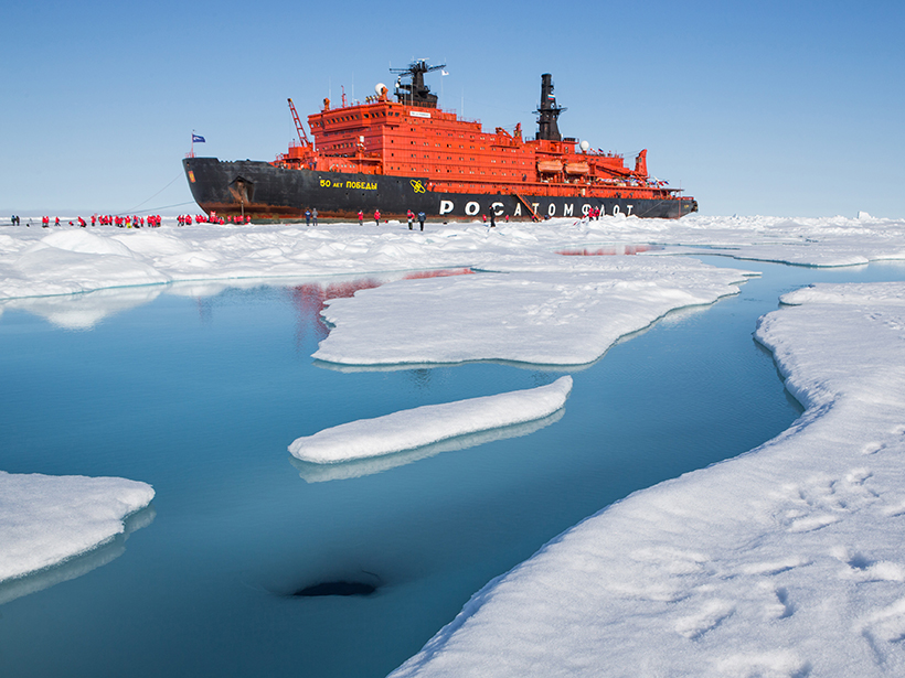 Citizen scientists examine melt pond at North Pole.