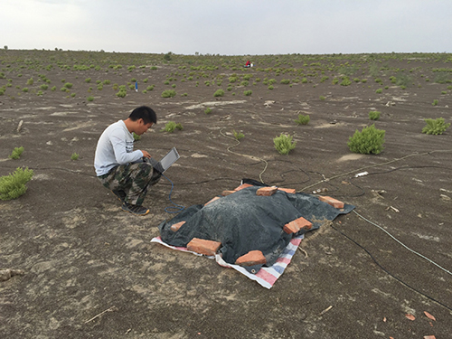 A student checks on magnetotelluric data quality in the western Junggar basin