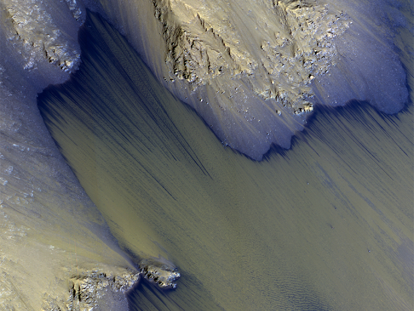 An enhanced-color view from NASA’s Mars Reconnaissance Orbiter High Resolution Imaging Science Experiment(HiRISE) shows rugged, canyon walls surfaces where Recurring Slope Lineae (RSL) are frequently detected in Coprates Chasma, Valles Marineris