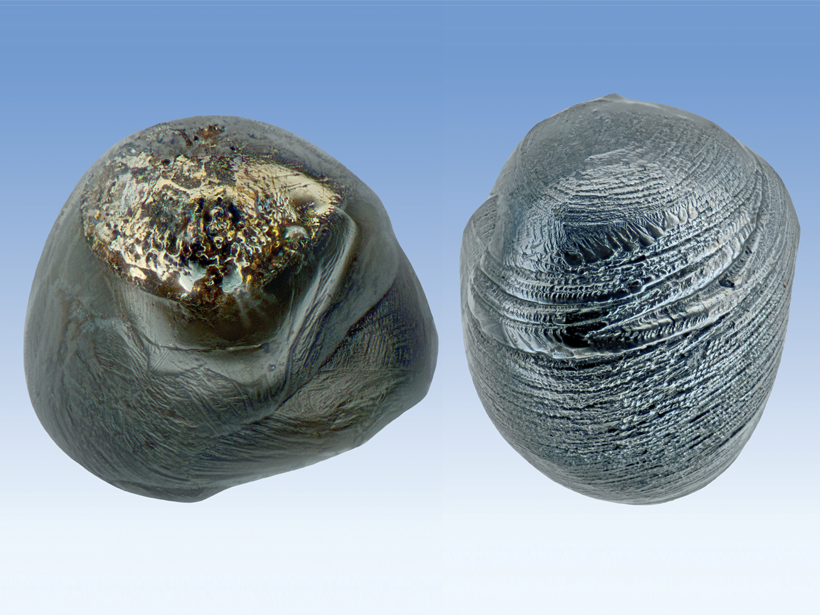 Two shiny, metallic micrometeorites.