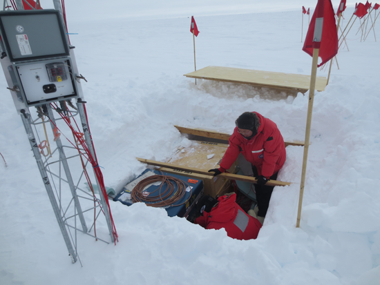 Team members work on the central pit of the AAL-PIP platform during testing near South Pole station.