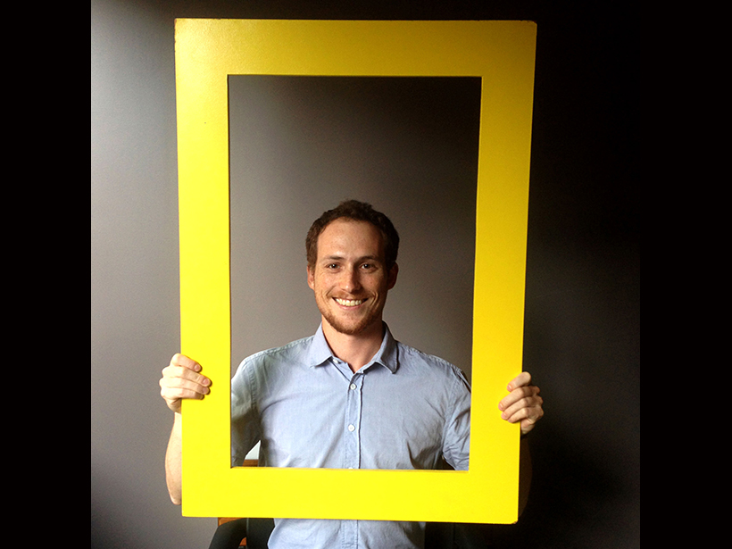 Aaron Sidder poses with National Geographic's famous yellow border.