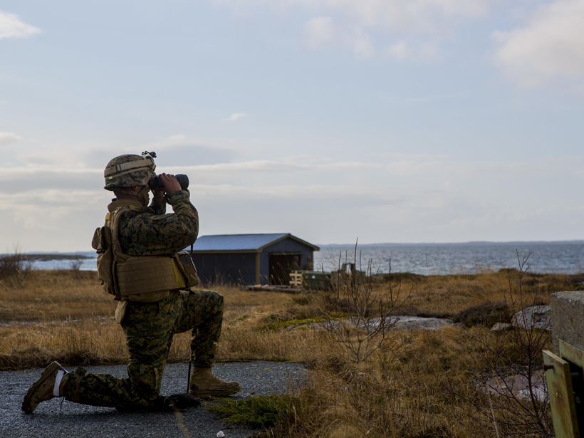 A member of the U.S. Marine Corps views the impact of a missile fired as part of NATO exercise Cold Response 16, a military-academia partnership.