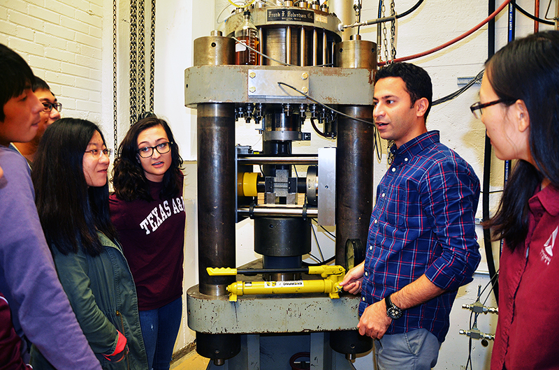 Students gather in rock deformation laboratory to learn about friction experiments.