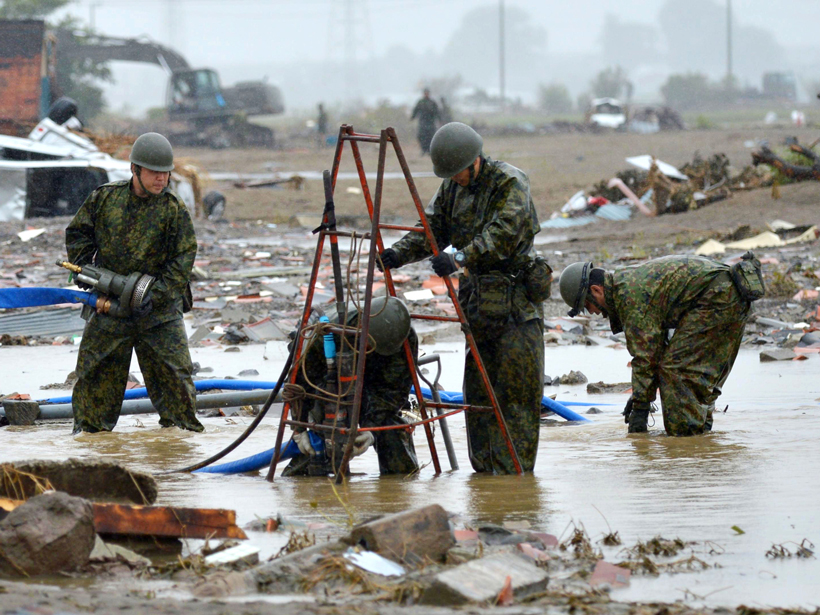 Japan’s Self-Defense Forces personnel examine a still-inundated area following the Kinu River’s 10 September flood.