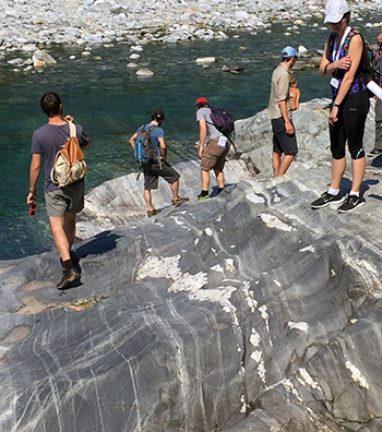 A group examines migmatitic orthogneisses along the Maggia River.