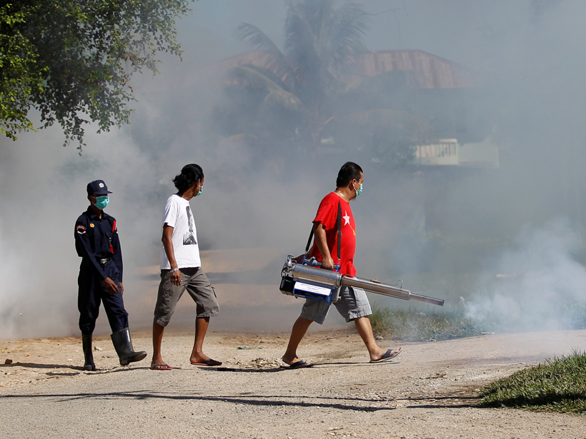 Volunteers fumigate against Zika-transmitting mosquitoes along a street in Yangon, Myanmar.