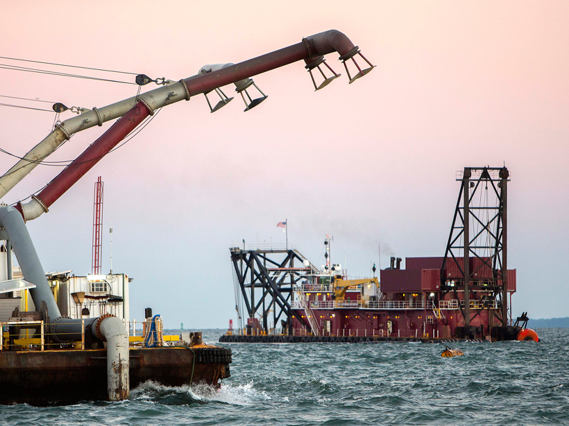A dredge (right) deepens the shipping channel to the port of Savannah, Ga., in 2015.