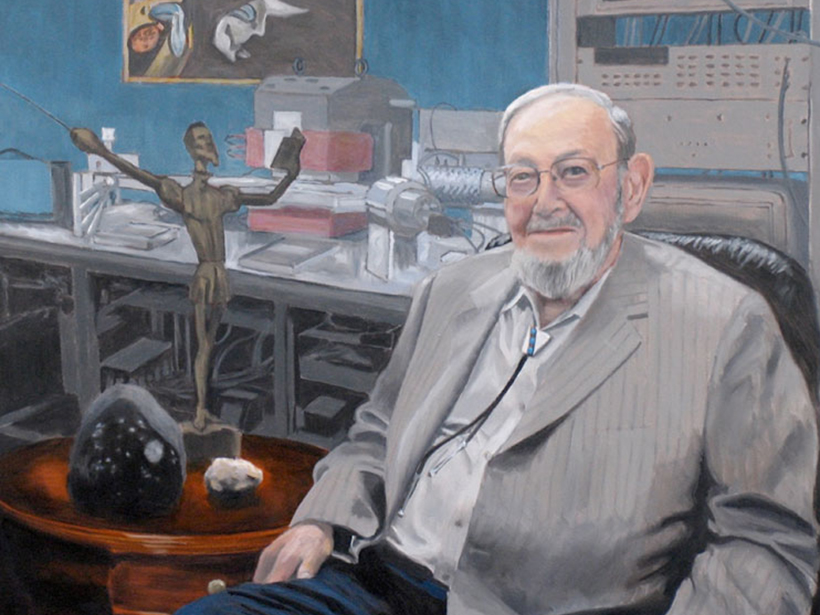 Gerald Wasserburg in front of the Lunatic I mass spectrometer with the Allende meteorite and a lunar rock on the table beside him