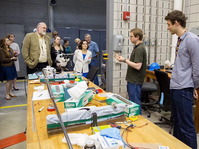 Córdova (in white blazer) tours the National High Magnetic Field Laboratory at Florida State University, Tallahassee, in March.