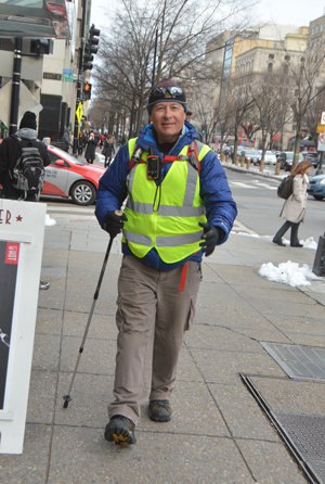 Rick Spinrad strides through downtown Washington, D. C., on his “long walk home” from Cape Henlopen, Del., to Newport, Ore.