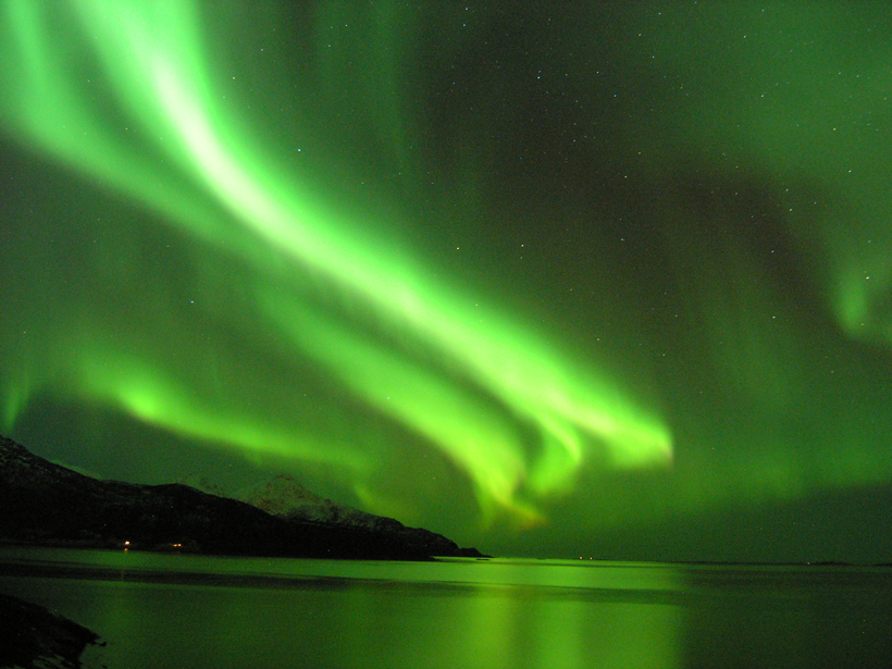 An aurora glows above Tromso, Norway, in 2010.