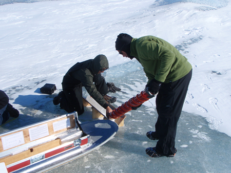 Scientists extracting a core from the ice.