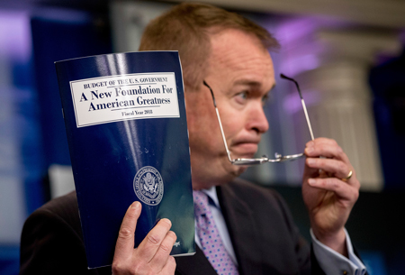 Mick Mulvaney, director of the White House Office of Management and Budget, holds up a copy of President Donald Trump’s proposed fiscal year 2018 federal budget.