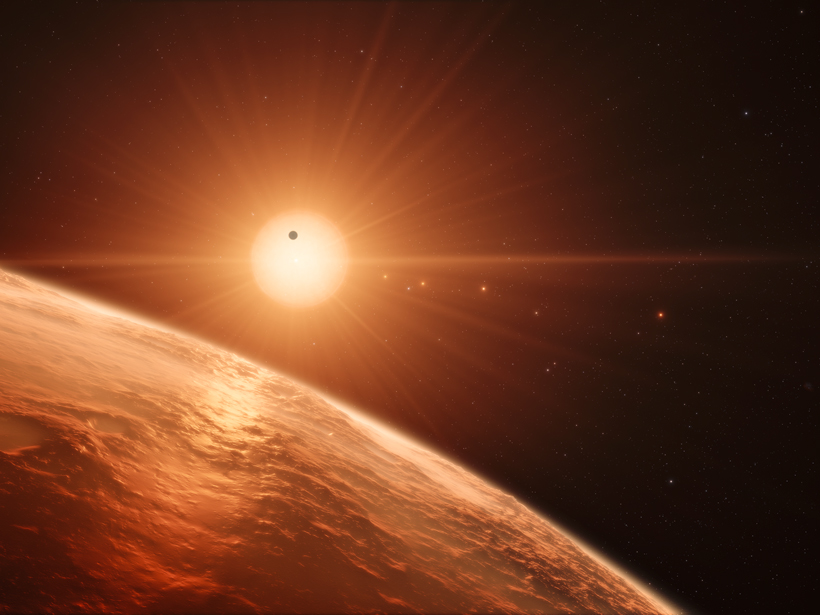 An artist’s impression shows the view from the surface of one of the seven worlds that circle the cool dwarf star TRAPPIST-1.
