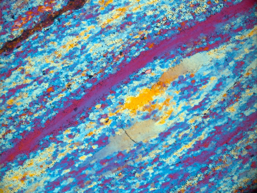 Optical photo taken with gypsum plate and a petrological microscope.