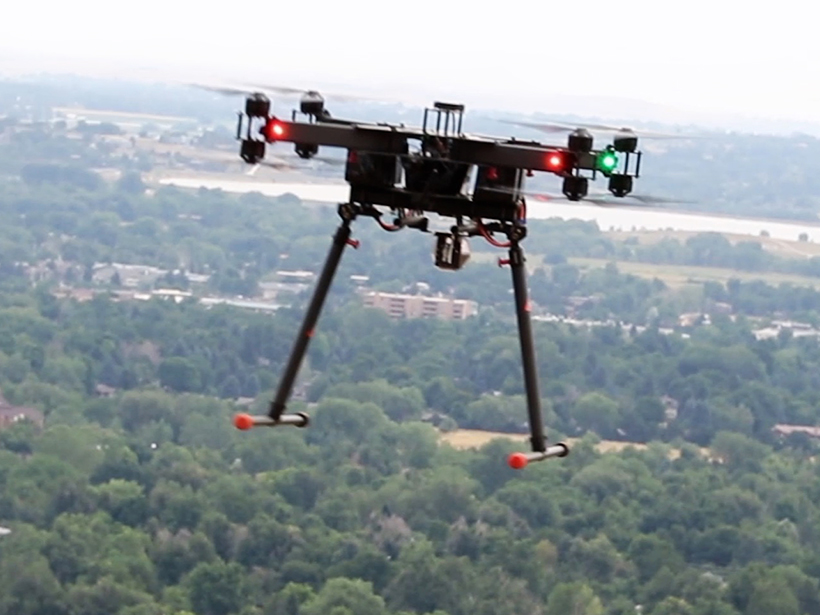 A multicopter fitted with a retroreflector to receive a laser frequency comb signal.