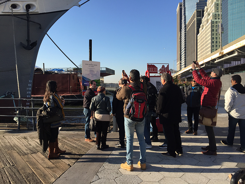 Representatives from NYC and Rio look at the 2012 high-water mark from Hurricane Sandy at New York’s Battery Park.