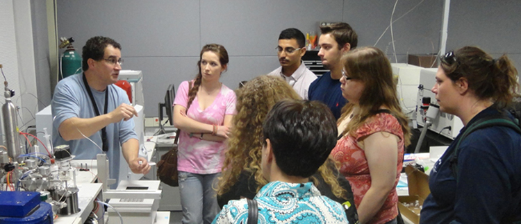 College class on a trip to a lab.