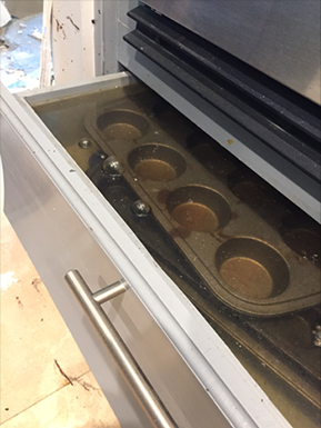 A drawer under an oven remains flooded 4 days after waters inundated a Houston home during Tropical Storm Harvey.