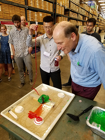 Using green gelatin and red-colored water to simulate the way magma intrusion breaks up Earth’s crust