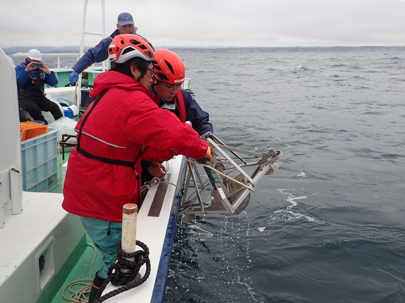 Monitoring team collecting a marine sediment sample near Fukushima Daiichi.
