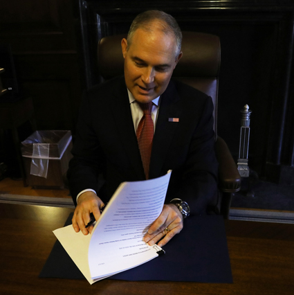 EPA administrator Scott Pruitt signs the notice to propose repealing the Clean Power Plan.