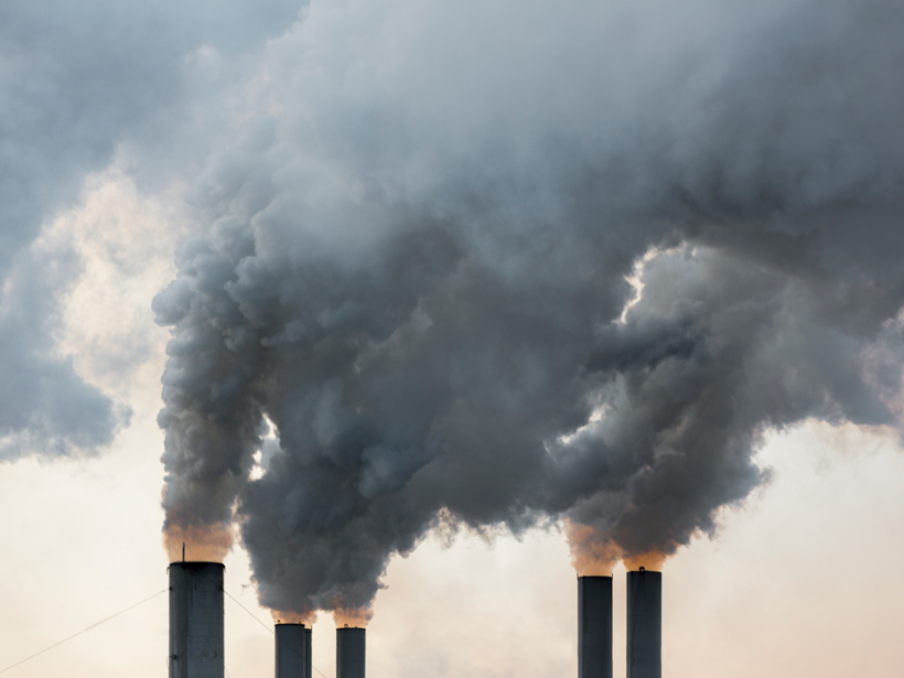 Plumes of smoke rise from chimneys at an industrial area in Greece.