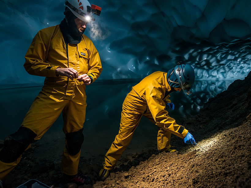 Lee Florea and Tabbatha Cavendish collect soil samples for microbial analysis in an ice cave near the summit of Mount Rainier.