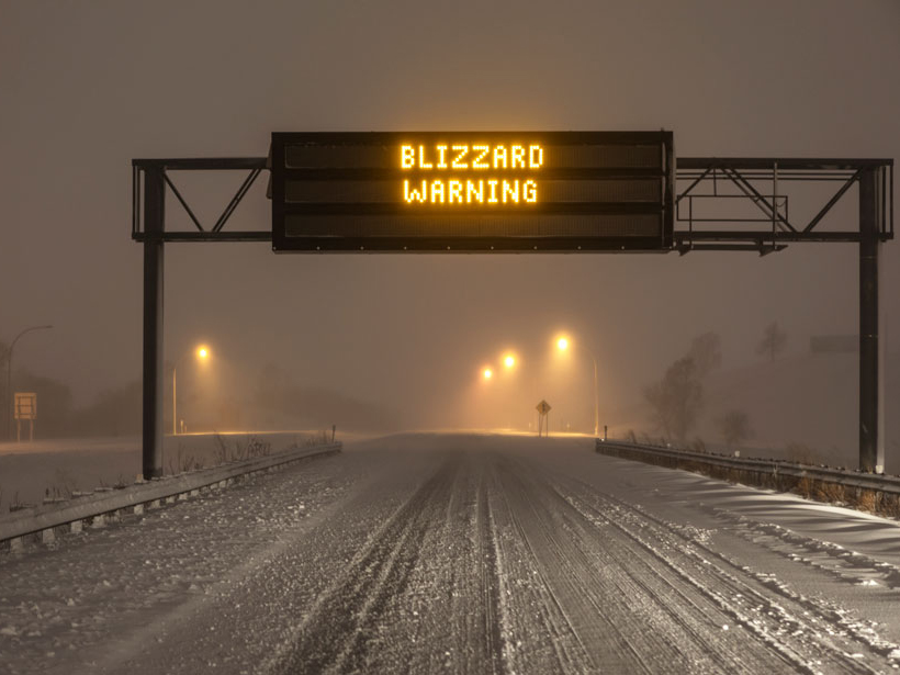 Blizzard warning sign on highway