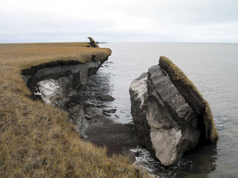 A collapsed block of ice-rich permafrost sits in shoreline waters in Drew Point, Alaska.