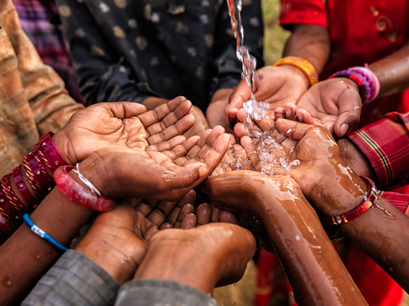 Hands of poor African children asking for drinking water.